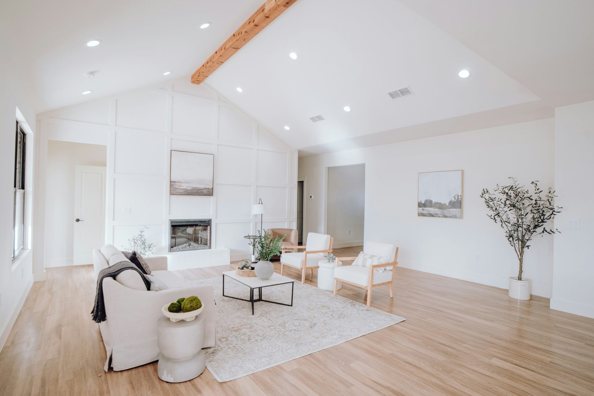 ein Wohnzimmer mit weißen Möbeln und Holzböden
